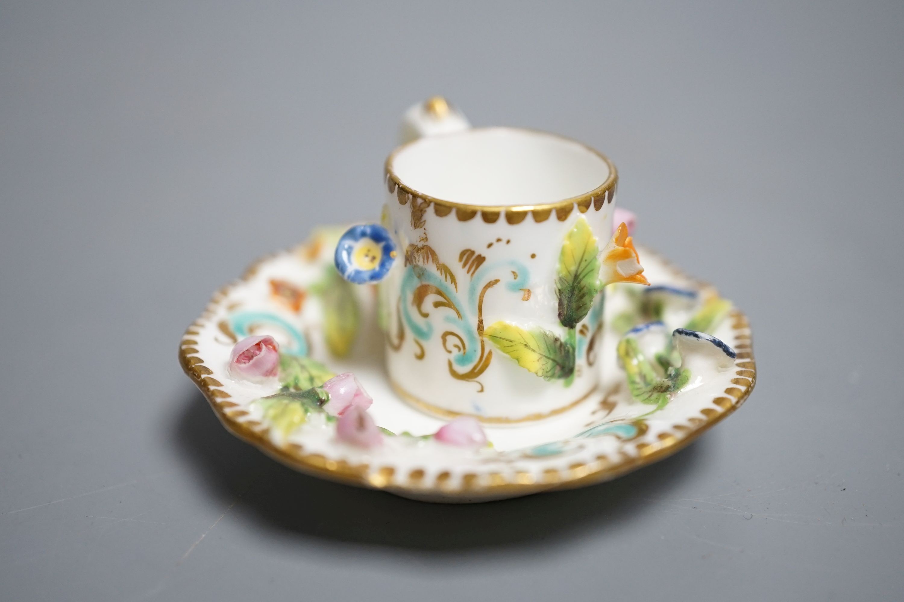 A Coalbrookdale miniature flower encrusted cup and saucer, c.1820. Provenance - Mona Sattin collection of miniature cups and saucers, collection no. 194.